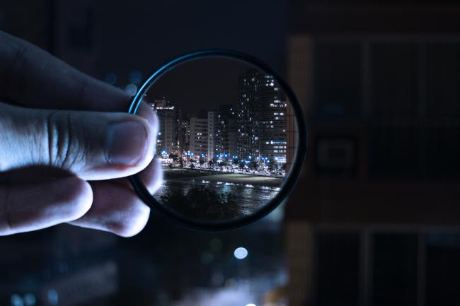 night shot of a city through a magnifying glass